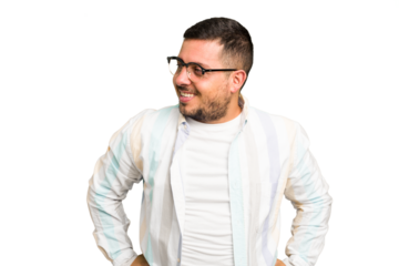 Young caucasian man isolated laughs happily and has fun keeping hands on stomach.