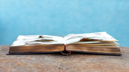 An open burnt book on a rusty metal surface