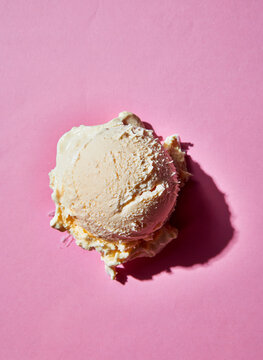 Vanilla ice cream scoop on pink background