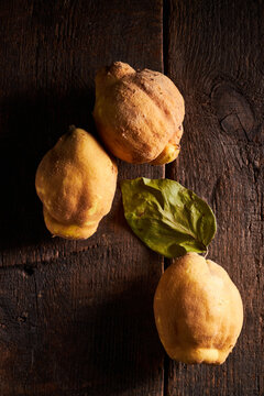 Fresh yellow lemons serving on wooden surface