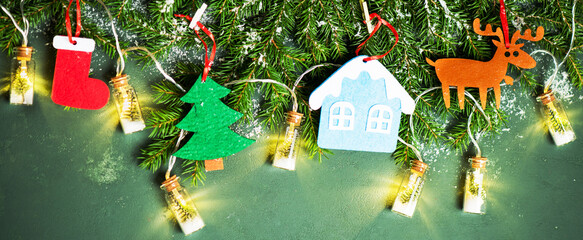 Christmas banner with fir branches and Christmas toys and garland, top view. Festive new year background.