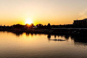 Fototapeta na wymiar Sunrise Over A River With A Boat
