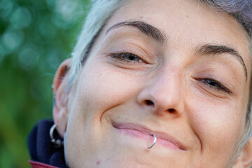 close-up portrait of a young non binary person with blue eyes. Gender identity.