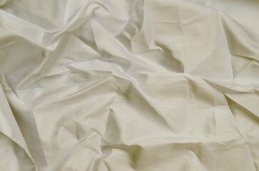 smooth texture smooth cloth surface. crumpled beige satin fabric background