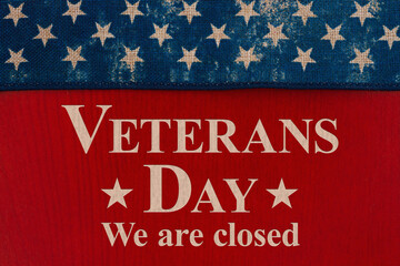 Closed Veterans Day sign with stars on red wood