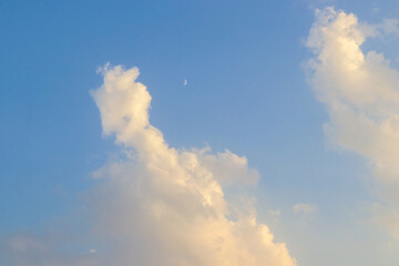 Moon in daylight On the bright sky, clouds and blue sky
