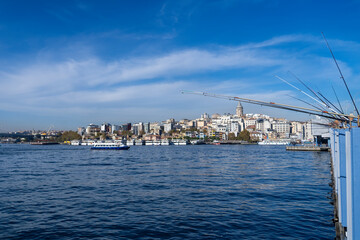 Fototapeta premium Fisherman fishing at Galata Bridge, crowded bridge side with many fisherman.