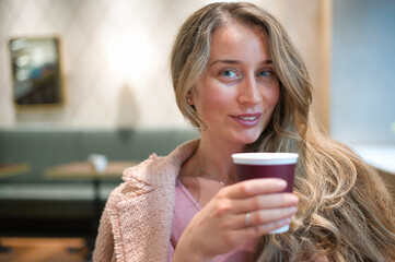 Happy woman drinking coffee in a restaurant
