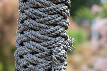 Closeup of ropes tied around a wooden pole