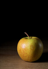 yellow apple on a wooden background