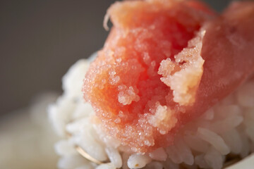 Close-up of salted pollack roe over cooked rice