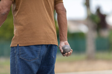 Petanque player who is about to throw his ball