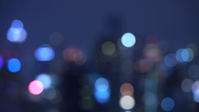Abstract urban night light bokeh defocused with skyscrapers. urban life for creative concept. horizontal 4k height resolutions 2160 x 3840