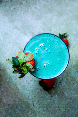 Teal Fruit Smoothie with Strawberry Garnish