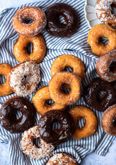 Mix of chocolate, lemon, sugar and coconut donuts in summer towel