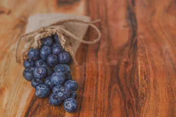 fresh blueberries in a raffia bag