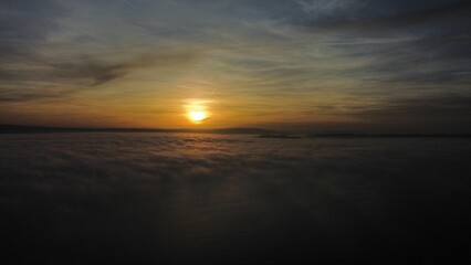 Scenic shot of fiery sunset above the clouds in Meersburg, Germany, for background