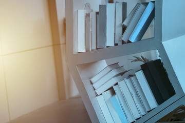 books on a wooden shelf. books are placed on a wooden shelf in the library.