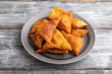 nachos on gray plate on a gray wooden background. Side view.