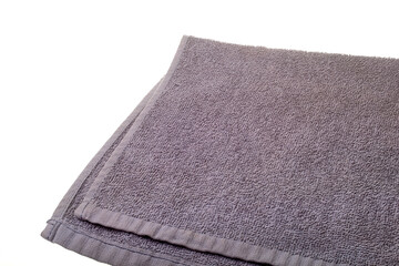 Fototapeta na wymiar Grey towel on a white background. A complex towel on a white background.