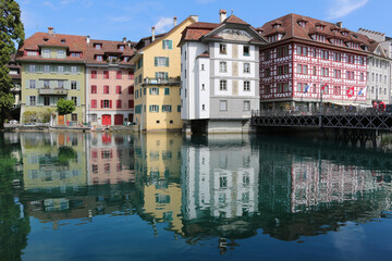 Fototapeta na wymiar Water reflections of townhouses in the river (Lucerne, Switzerland)