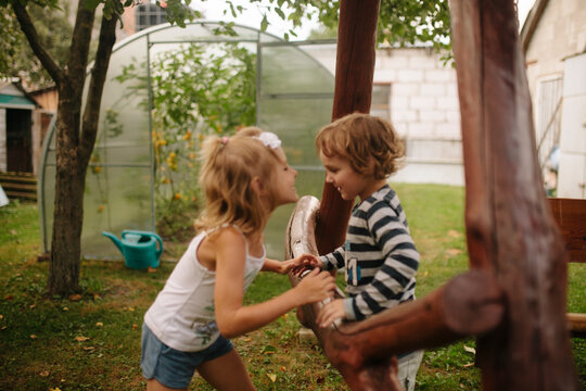Children play in the courtyard of a country house