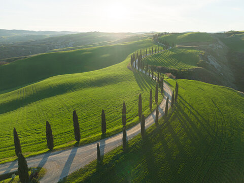 tuscany fields and roads from aerial view at sunrise