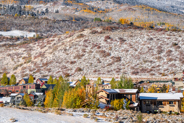 Aspen, Colorado rocky mountains with ranch farm pasture covered in snow after winter with yellow autumn trees, houses by mountain cityscape - obrazy, fototapety, plakaty