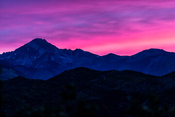 Pink purple sunset in ski resort town of Aspen, Colorado with Rocky mountains of Cozy point...