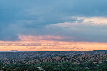 Sangre De Cristo mountains sunset on Bishops Lodge Road street in Santa Fe, New Mexico with residential Tesuque residential houses private community