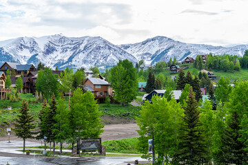 Mount Crested Butte, Colorado small village ski resort town in summer with cloudy sunrise morning...