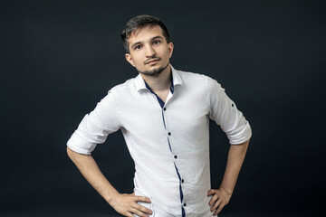 a man stands with his hands in bokeh and looks at the camera on a black background.