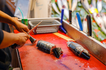 Fisherman cleaning sea fish in the market