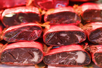 Turkish bacon, pastrami, kayseri pastirma. Turkish pastirma or basturma in the street grocery market with slicer machine