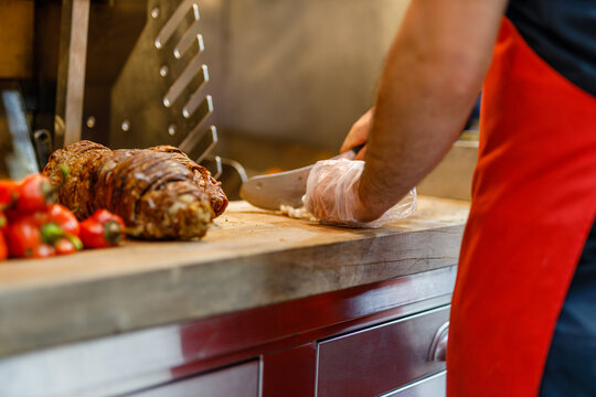 Making of Turkish Street Food Kokorec rolls made with lamb bowel roasting in wood fired oven.