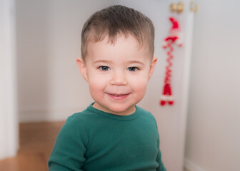 young boy playing and looking at books in his room