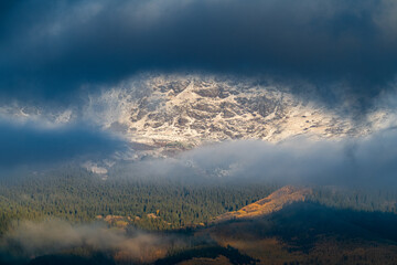 Snowy Fall Sunrise over Colorado Mountains, Closeup shot looking through the clouds