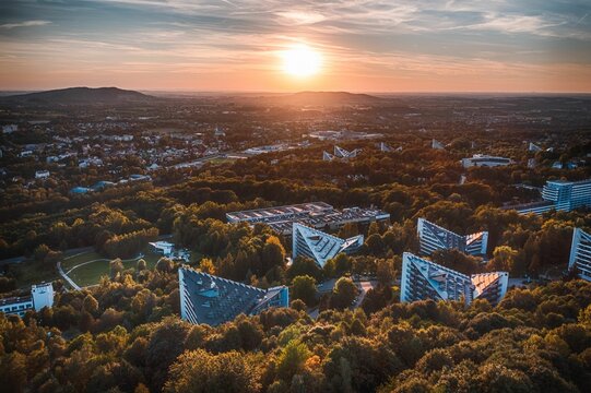 High-angle shot of architecture and trees during sunset on the horizon in Ustron, Poland