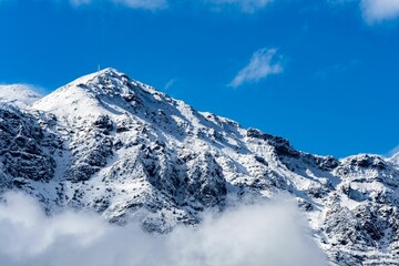 Fototapeta na wymiar Landscape of snowy mountain under sunny blue sky