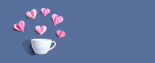 Coffee cup with paper craft hearts - flat lay