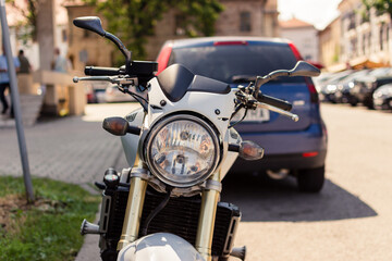 Front view of a motorcycle with headlights in an urban area