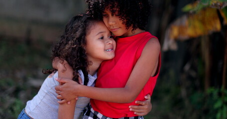 Children hugging each other. Two little hispanic girls embrace