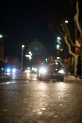 Blurred vehicle front view at night from street view person crossing