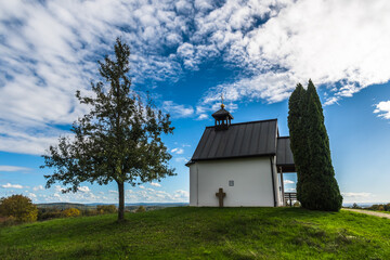 Small chapel on a hill in sunny autumn