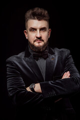portrait of a man in a jacket and in the studio on a black background
