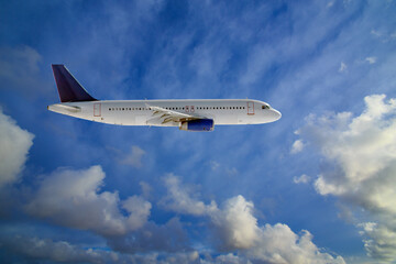 Passenger plane flies in cloudy sky