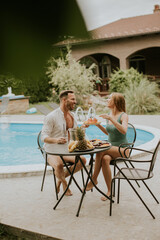 Young couple sitting in the backyard