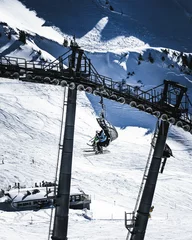Tuinposter Vertical shot of a ski lift in the Alps © Wnrt-93/Wirestock Creators