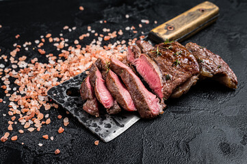 Sliced grilled Lamb fillet steak, mutton meat from leg. Black background. Top view