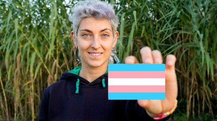 non-binary person claims gender identity with a transgender flag